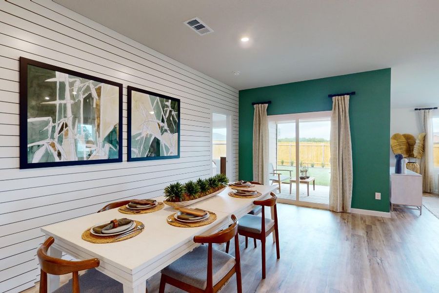 A dining room with a table set. A dining room with a table set.