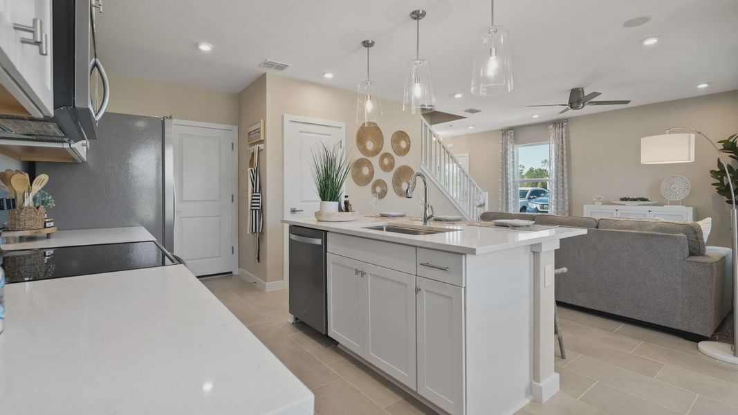 Cyrene at Harmony by DRB Homes offers an open-concept kitchen and living room—ideal for gathering with family and friends. Cyrene at Harmony by DRB Homes offers an open-concept kitchen and living room—ideal for gathering with family and friends.