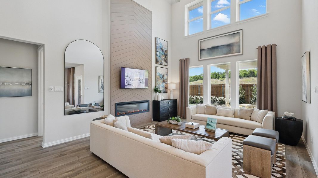 Soaring ceilings and expansive windows elevate this Green Oaks Preserve living area with elegant design touches. Soaring ceilings and expansive windows elevate this Green Oaks Preserve living area with elegant design touches.