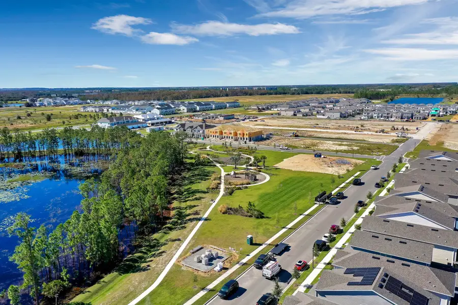 Aerial view of the Harvest at Ovation - Townhomes community in Winter Garden, FL, showing layout and nearby surroundings (Image 16).