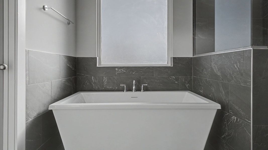 Primary Bathroom with luxurious tub with natural light from window Primary Bathroom with luxurious tub with natural light from window