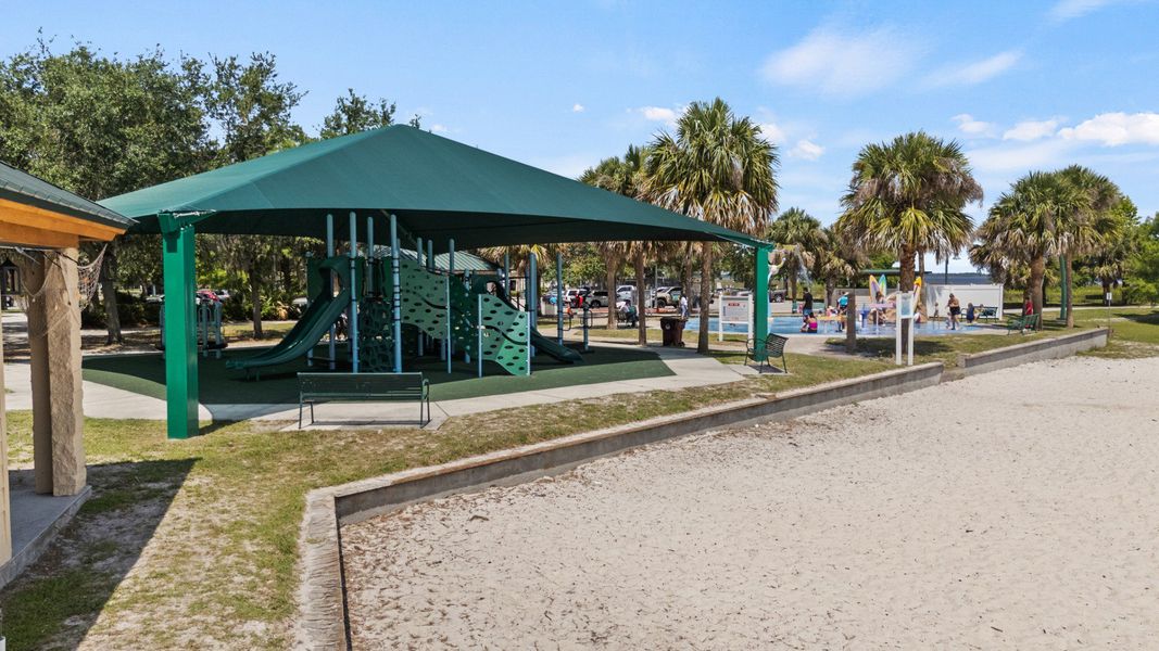 Shaded playground at Lakefront Park in St. Cloud, FL with splash pad and beach area nearby, minutes from Cyrene at Harmony. Shaded playground at Lakefront Park in St. Cloud, FL with splash pad and beach area nearby, minutes from Cyrene at Harmony.