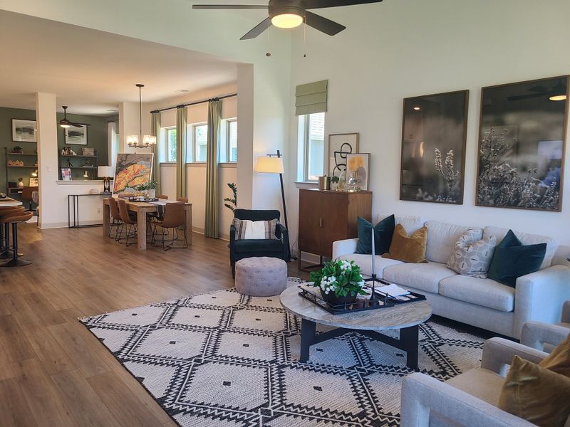 A spacious open-plan living area with modern decor, cozy seating, and an elegant dining space.