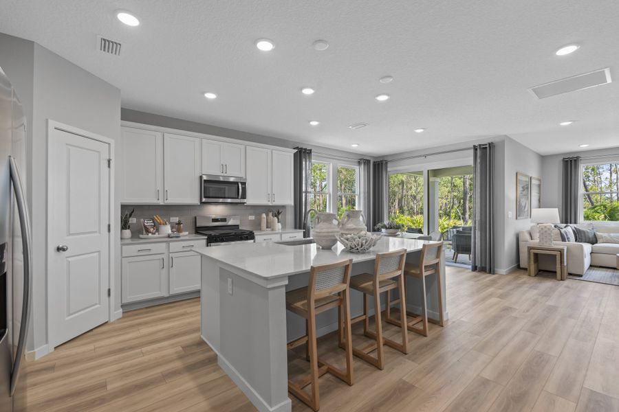 Coronado Model Home Kitchen with White Cabinets at Reserve East in Flagler Beach