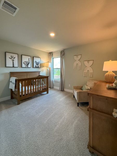 A cozy nursery featuring animal art, wooden crib, and gentle lighting for a serene environment.