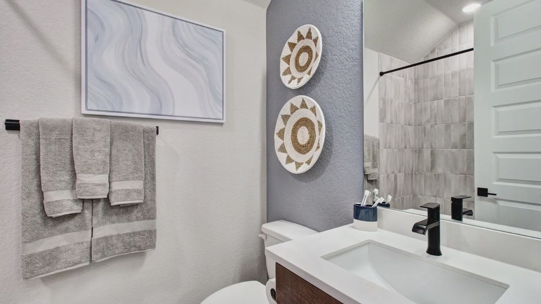 Luxurious modern bathroom at Sunflower Ridge featuring sleek fixtures and artistic wall decor.