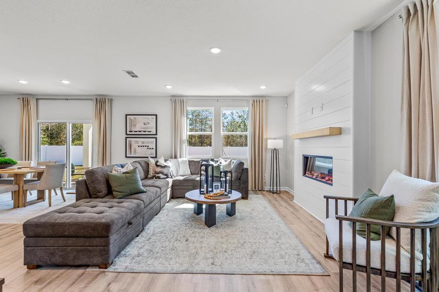 A living room with a couch and a table. A living room with a couch and a table.
