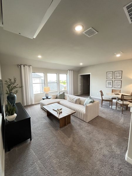 A cozy living space with a plush sectional, elegant coffee table, and abundant natural light. Perfect for relaxation.