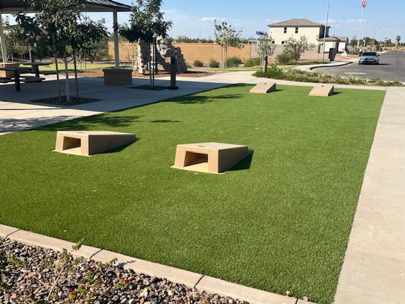 A lush green park with benches and shaded areas in Laveen Vistas III by Homes by Towne (Laveen, AZ). A lush green park with benches and shaded areas in Laveen Vistas III by Homes by Towne (Laveen, AZ).