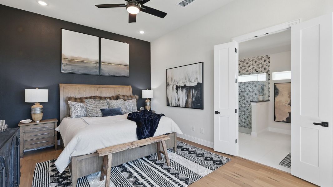 Luxurious bedroom with bespoke wood accents and chic ensuite bathroom in Green Oaks Preserve. Luxurious bedroom with bespoke wood accents and chic ensuite bathroom in Green Oaks Preserve.