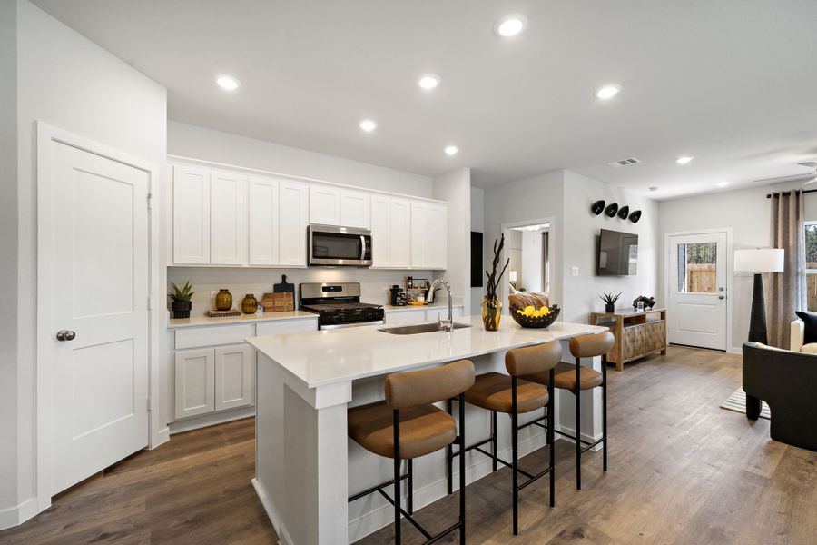 A kitchen with white cabinets.
