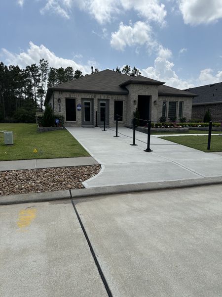 A charming brick home with a paved driveway in Porters Mill by D.R. Horton (New Caney, TX).