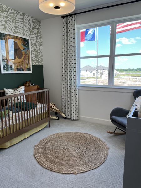 A chic nursery with leafy wallpaper, playful decor, and modern accents, featuring a cozy crib and soft lighting. A chic nursery with leafy wallpaper, playful decor, and modern accents, featuring a cozy crib and soft lighting.