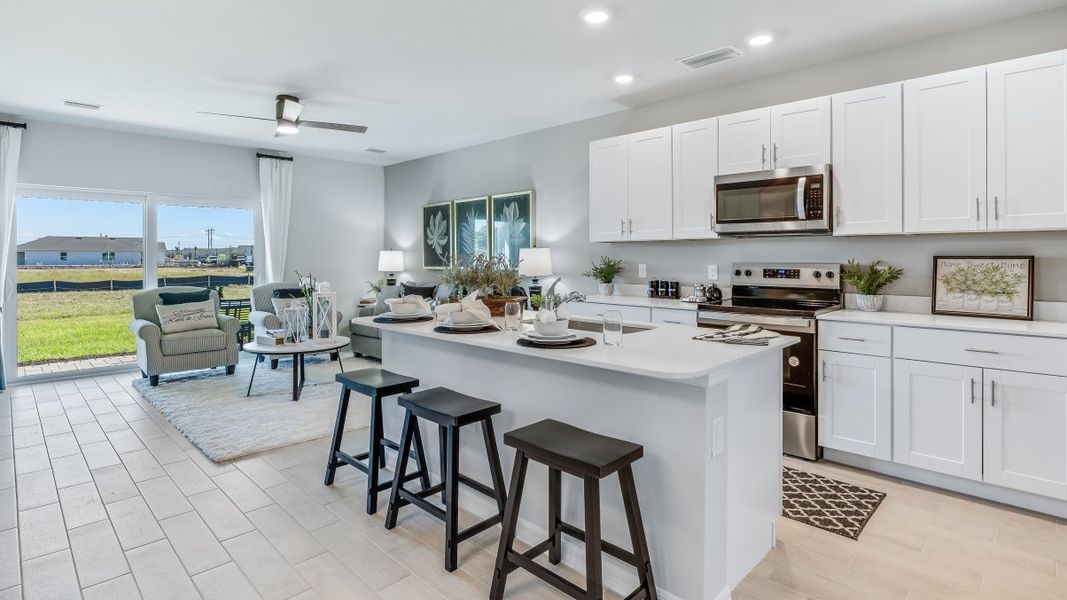 Furnished interior in a model home at Asher Park in Lehigh Acres (Image 16).