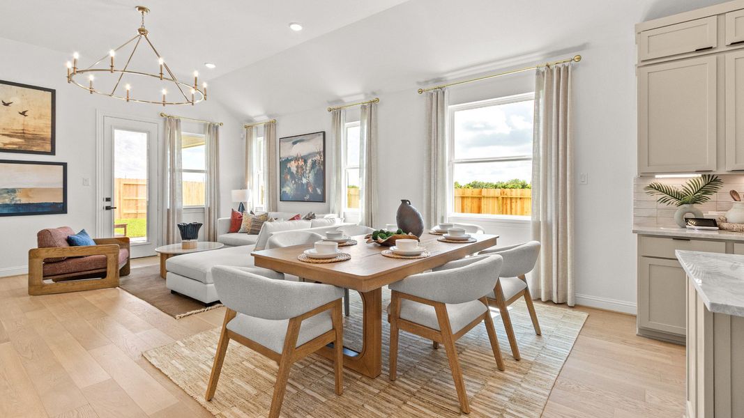 Open-concept breakfast and living area featuring airy interiors and a seamless flow throughout the home in Azalea community.