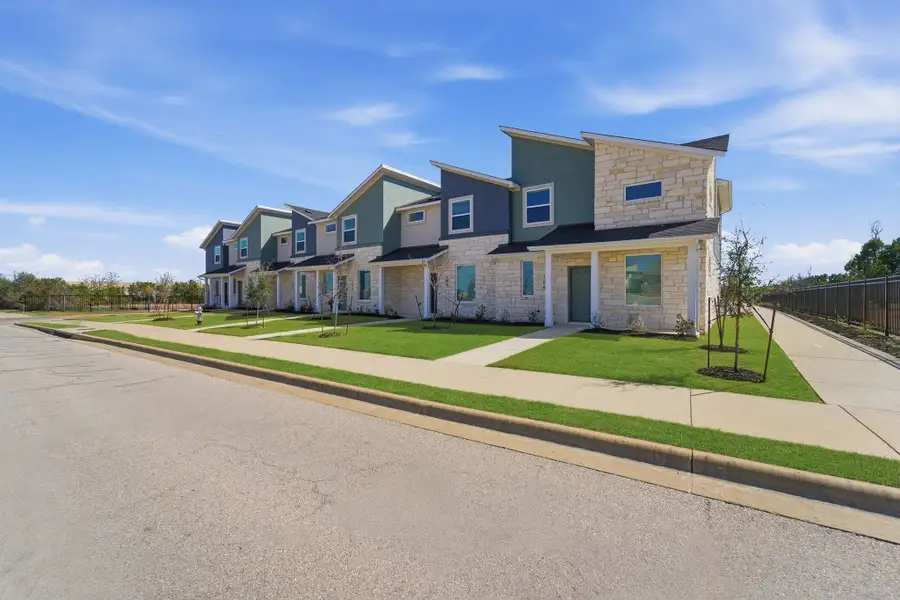 Front exterior of a home in the Municipal Drive Townhomes community, located in Leander, TX (Image 2).