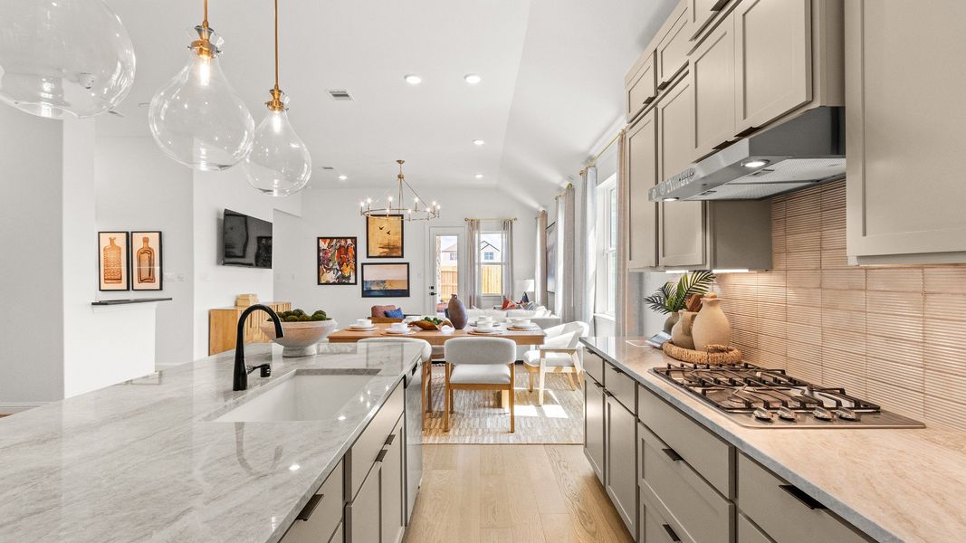Kitchen showcasing stylish lighting, modern finishes, and an inviting atmosphere in Azalea community.