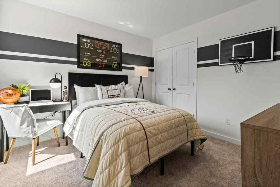 A bedroom with a bed and a table.