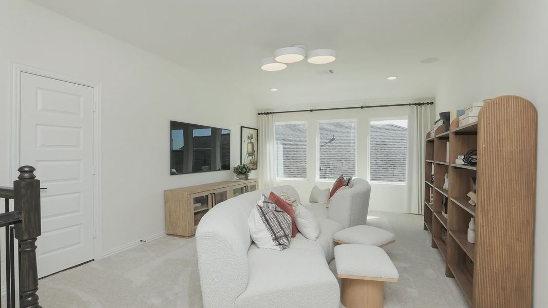 Luxurious living area with plush seating, bespoke wood shelving, and ample natural light in Brookewater. Luxurious living area with plush seating, bespoke wood shelving, and ample natural light in Brookewater.