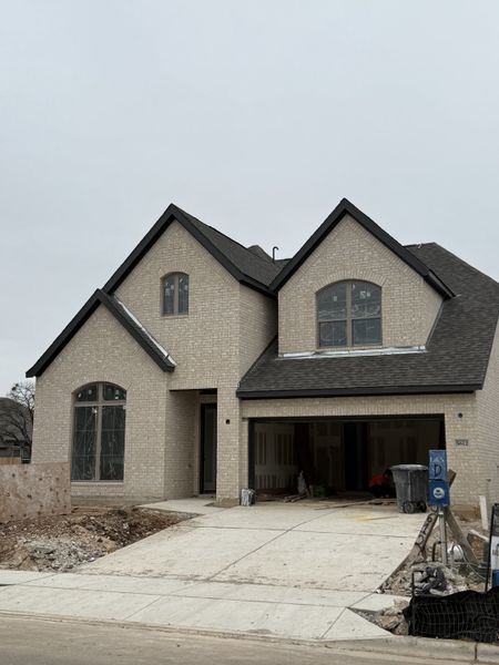 Elegant brick home with dark roofing in Parkside Peninsula 50' by Perry Homes, Georgetown, TX.
