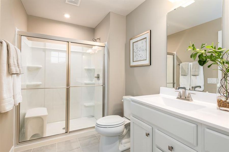 Owner’s bath includes walk-in shower with seat and double vanity for daily comfort. Owner’s bath includes walk-in shower with seat and double vanity for daily comfort.