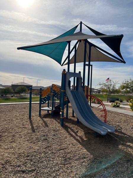 A vibrant playground with shaded slides and climbing structures in the Village at Sundance by Centex (Buckeye, AZ). A vibrant playground with shaded slides and climbing structures in the Village at Sundance by Centex (Buckeye, AZ).