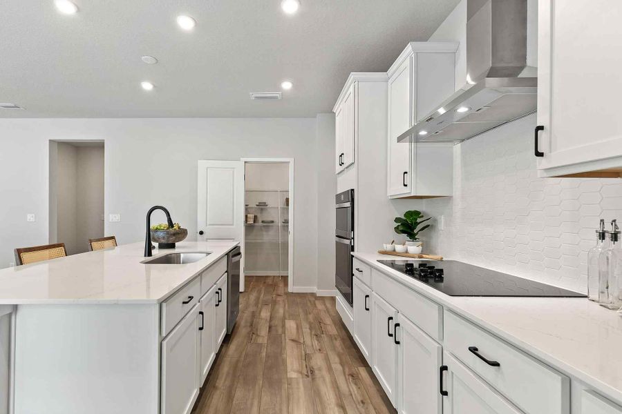 A kitchen with white cabinets.