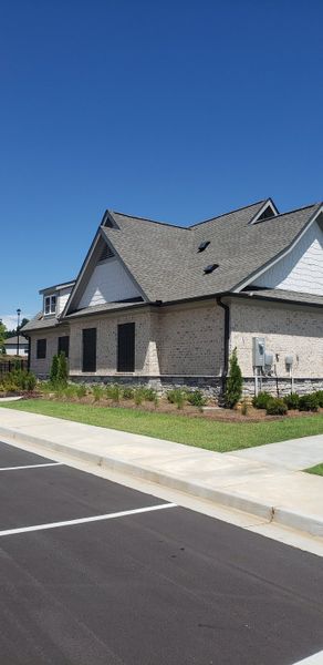 A charming brick home with gabled roof and manicured lawn in Timber Ridge: Timber Ridge 42' by Lennar (Douglasville, GA).