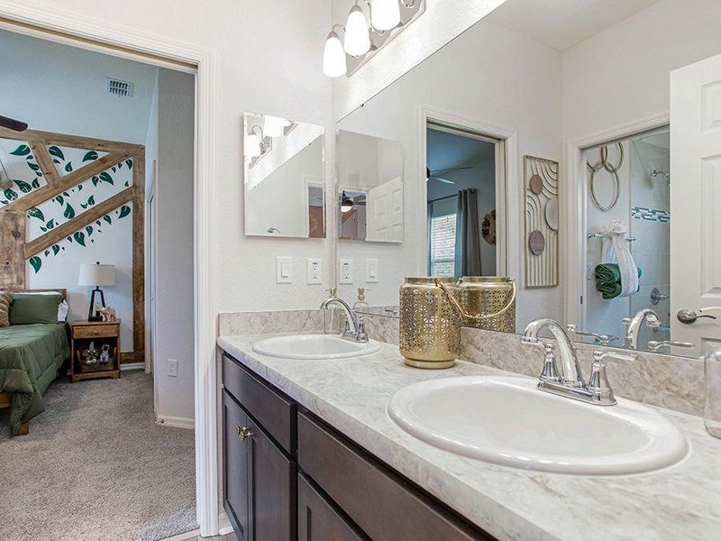 A Jack-and-Jill bath is accessed from bedrooms 3 and 4 - Shelby model home in Davenport, FL