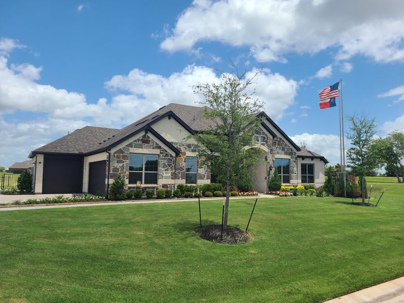 A charming stone-accented home with lush landscaping in Creekview Farms by Altura Homes (Greenville, TX). A charming stone-accented home with lush landscaping in Creekview Farms by Altura Homes (Greenville, TX).