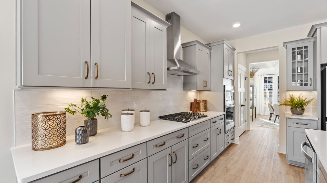 Superior kitchen with quartz countertops, pendant lighting, and a generously sized island Superior kitchen with quartz countertops, pendant lighting, and a generously sized island