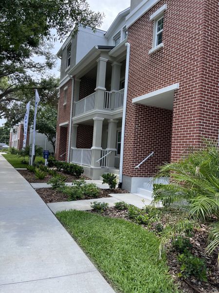 Charming red brick townhomes with spacious balconies in Townes at Manhattan Crossing by Lennar (Tampa, FL).