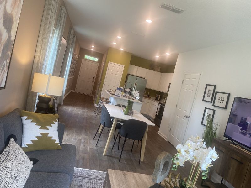 A welcoming open-concept living space featuring a cozy seating area, modern kitchen, and elegant decor elements. A welcoming open-concept living space featuring a cozy seating area, modern kitchen, and elegant decor elements.