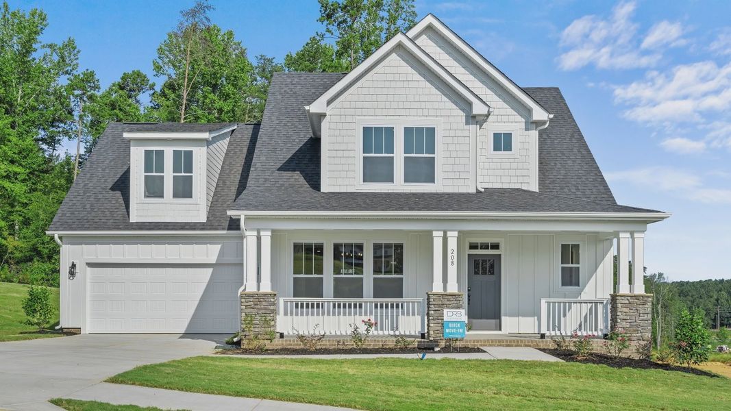 Beautiful white exterior home with front porch at Kayfield at Midway by DRB Homes in Anderson, SC