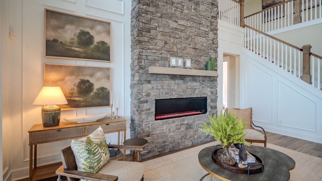 Elate II Gathering room with impressive 2-story fireplace, acting as a centerpiece to the home Elate II Gathering room with impressive 2-story fireplace, acting as a centerpiece to the home