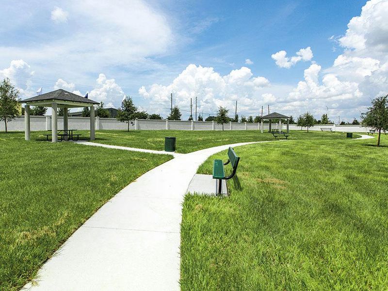 Common areas include gazebos, picnic tables, and benches situated along a meandering path