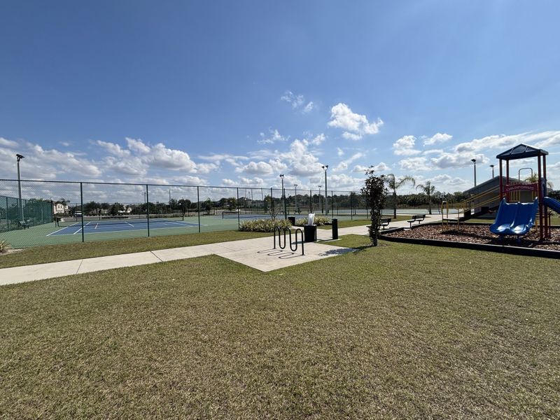 A spacious basketball court with professional markings and scenic surroundings in Avian Pointe Townhomes by D.R. Horton (Apopka, FL).