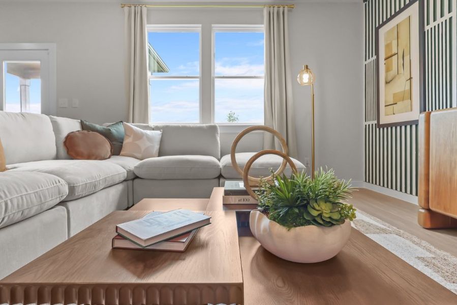 A living room with a table and chairs. A living room with a table and chairs.