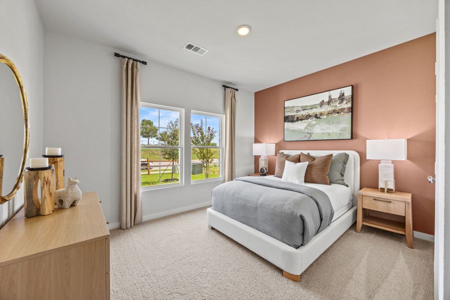 A bedroom with a large window. A bedroom with a large window.