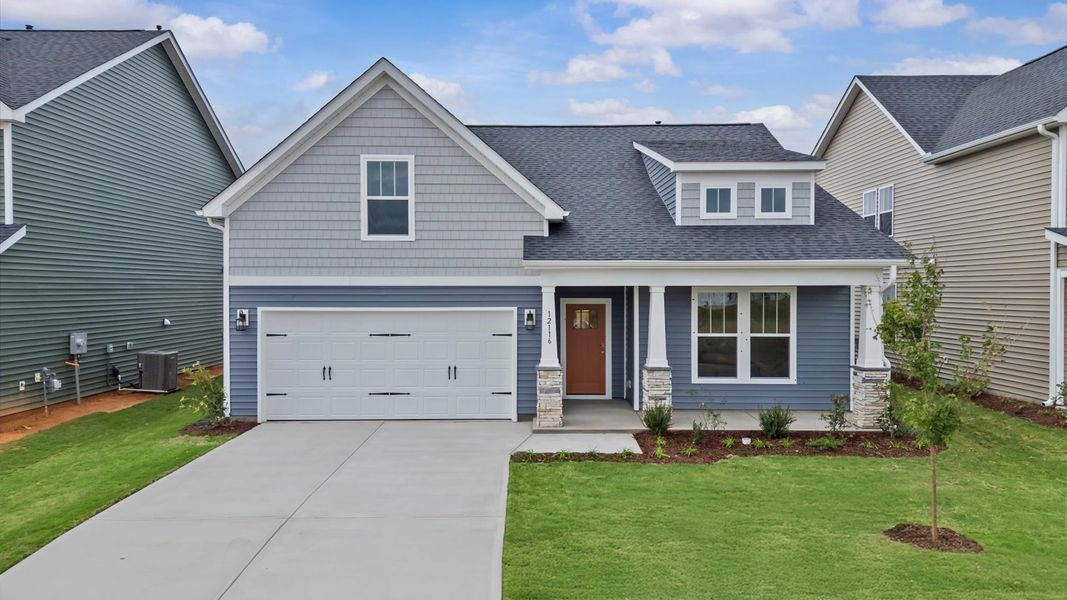 Exterior of a ranch style home in Inman, SC at Walnut Ridge by DRB Homes with stone columns
