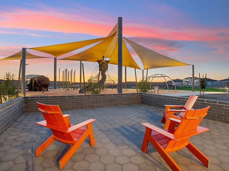 A patio with chairs and an umbrella. A patio with chairs and an umbrella.
