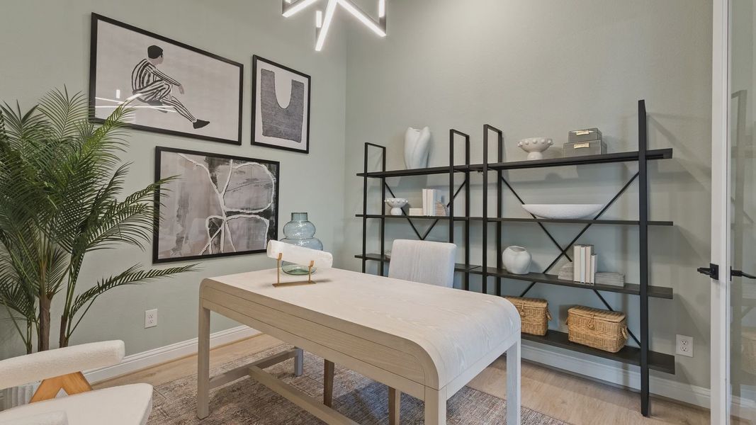 Discover elegance with a sculptural desk, geometric chandelier, and minimalistic shelving in Oakwood Estates. Discover elegance with a sculptural desk, geometric chandelier, and minimalistic shelving in Oakwood Estates.