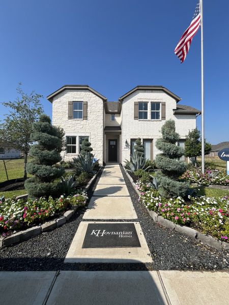A beautiful two-story white brick home with lush landscaping in Marvida by K. Hovnanian® Homes, Cypress, TX. A beautiful two-story white brick home with lush landscaping in Marvida by K. Hovnanian® Homes, Cypress, TX.