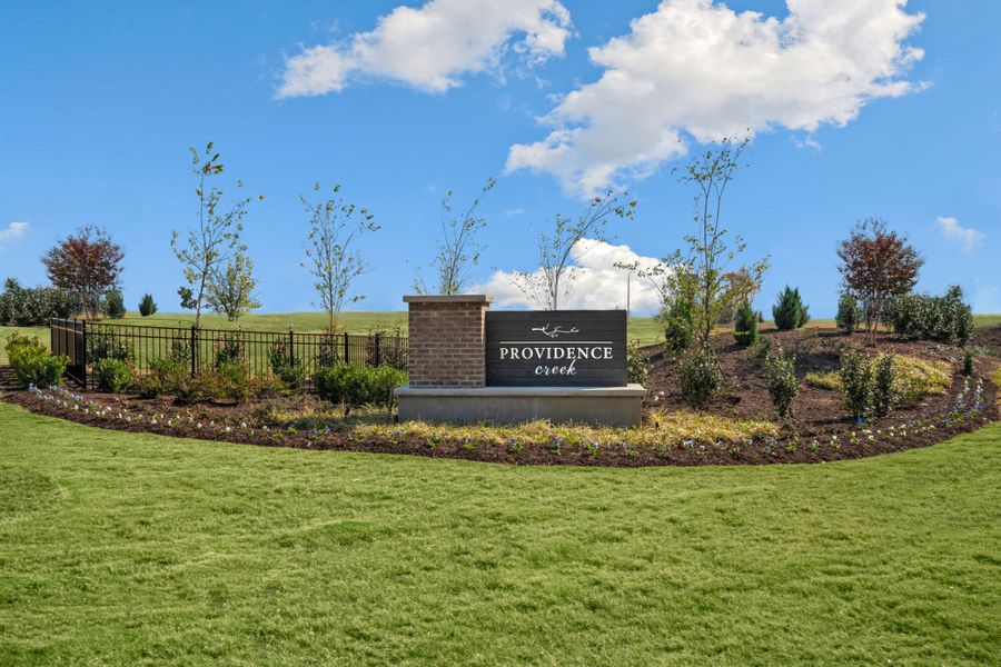 Entrance to the Providence Creek community in Fuquay Varina, NC, featuring signage and landscaping (Image 1).