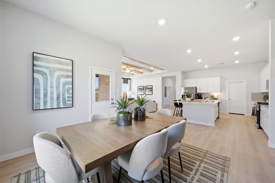 A dining room with a table and chairs.