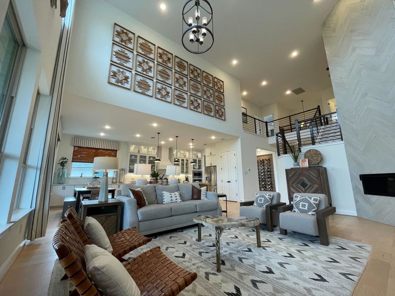 A spacious living area with vaulted ceilings, modern decor, and a stylish open layout. A spacious living area with vaulted ceilings, modern decor, and a stylish open layout.