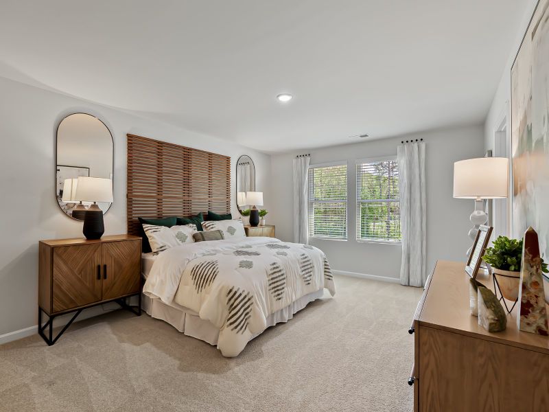 Unwind in the spacious primary suite featuring an ensuite bath, dual sinks and a walk-in closet.