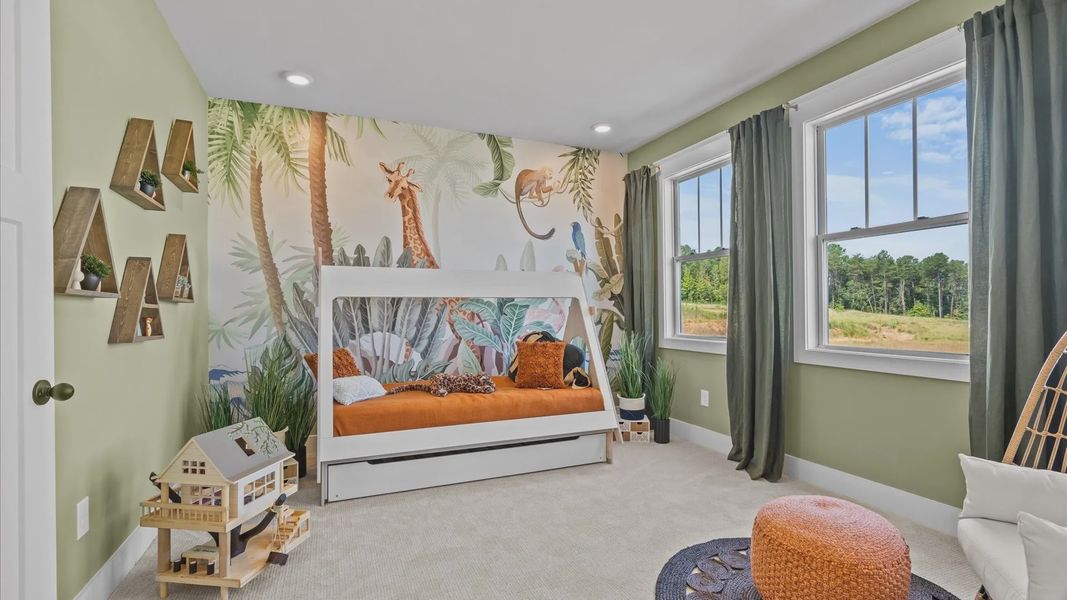 Secondary bedroom with green accents, large windows, and plush carpet at Kayfield at Midway by DRB Homes in Anderson, SC