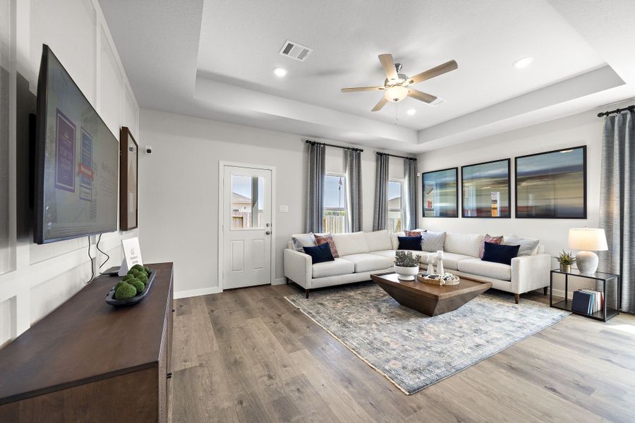 A living room with a large television and a couch.