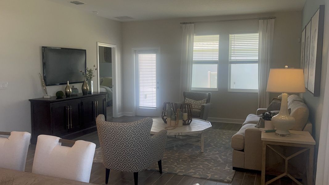 A cozy living room with elegant seating, a stylish rug, and ambient lighting, perfect for relaxation and entertainment.